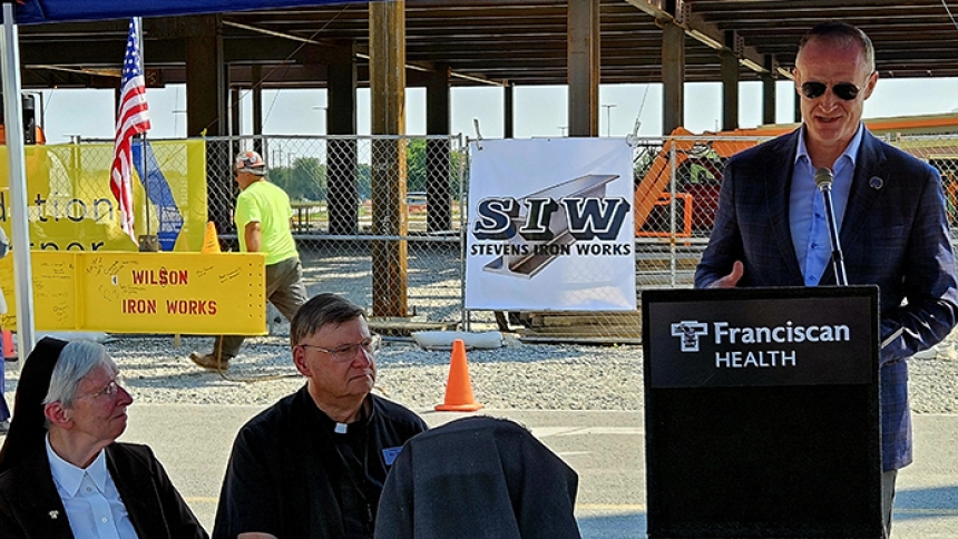  Franciscan Alliance Chairwoman of the Board of Trustees Sister M. Aline Shultz, OSF and Franciscan Health Crown Point Director of Spiritual Care The Rev. Tony Janik listen as The Dean and Barbara White Family Foundation Executive Director Bill Hanna speaks during the topping off ceremony Tuesday for The Dean and Barbara White Cancer Center. (Provided photo)