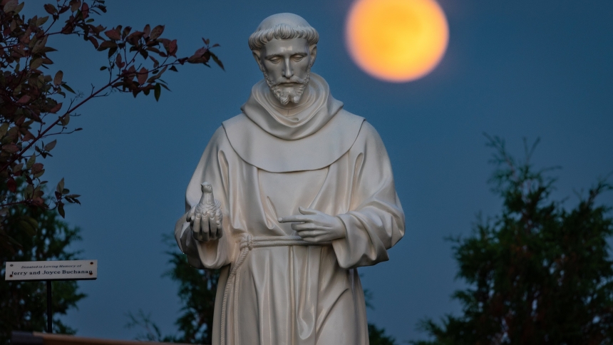A hunter's moon rises behind a statue of St. Francis of Assisi on the grounds of the National Shrine of Our Lady of Champion in Champion, Wis., Oct 8, 2022 (OSV News photo/Sam Lucero, CNS)