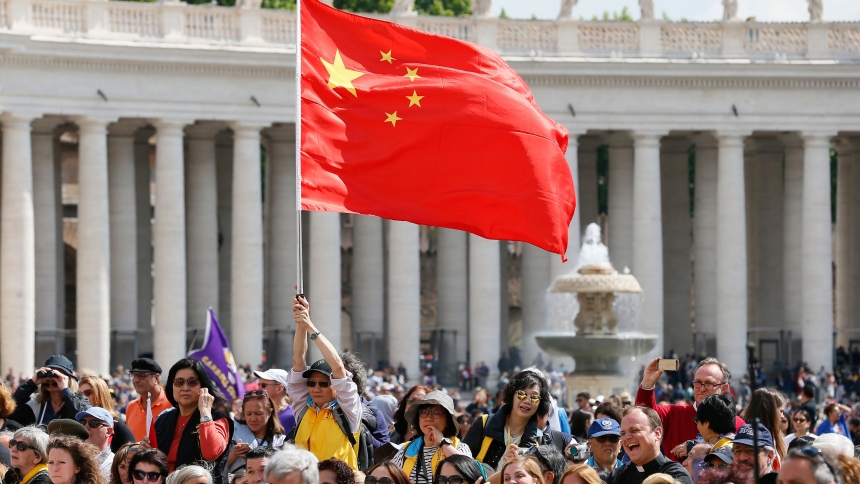 A visitor waves the flag of China in St. Peter's Square at the Vatican in this file photo from May 22, 2019. (CNS photo/Paul Haring
