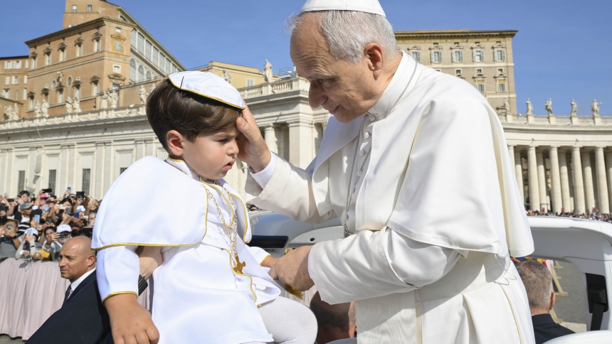 Pope Leo XIV greets a child dressed as the pope as he rides in the popemobile during the weekly general audience in St. Peter's Square at the Vatican Sept. 17, 2025. (CNS photo/Vatican Media)