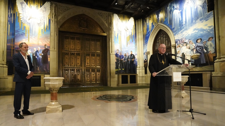 New York Cardinal Timothy M. Dolan speaks during the formal unveiling Sept. 18, 2025, of a 25-foot-high, four-panel mural in the narthex of St. Patrick's Cathedral in New York City. Looking on is artist Adam Cvijanovic, the mural's creator. The artwork depicts the 1879 Marian apparition in Knock, Ireland; people connected to the Catholic heritage and immigration history of the city of New York and the state; and first responders who serve the metropolitan area. (OSV News photo/Gregory A. Shemitz)