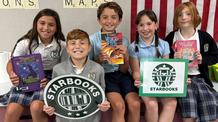 Ava Skinner, Triffin Ploutis, Michael Gonzalez, Adriana Borozan, and Kyra Martinez display book choices and cafe signs at the close of the book tasting event in Mrs. Wong’s classroom. (Provided photo)