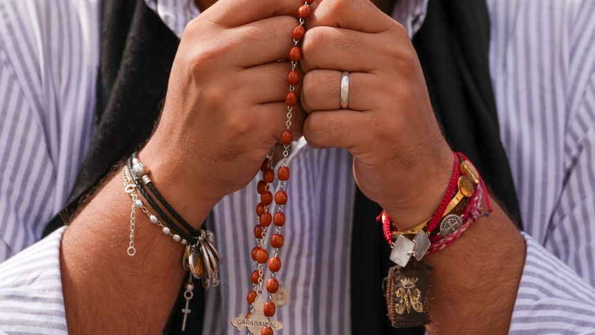 A person prays the rosary in St. Peter’s Square at the Vatican in this file photo from May 8, 2025. (CNS photo/Lola Gomez)