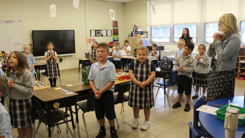 First graders in Catherine Rusin’s class open the school day with prayer at St. Michael School in Schererville, which is celebrating its 125th anniversary this year. A gala dinner, expected to reunite firmer students, parents and teachers, is planned for Friday, Sept. 26, at Innsbrook Country Club in Merrillville. (Marlene A. Zloza photo)