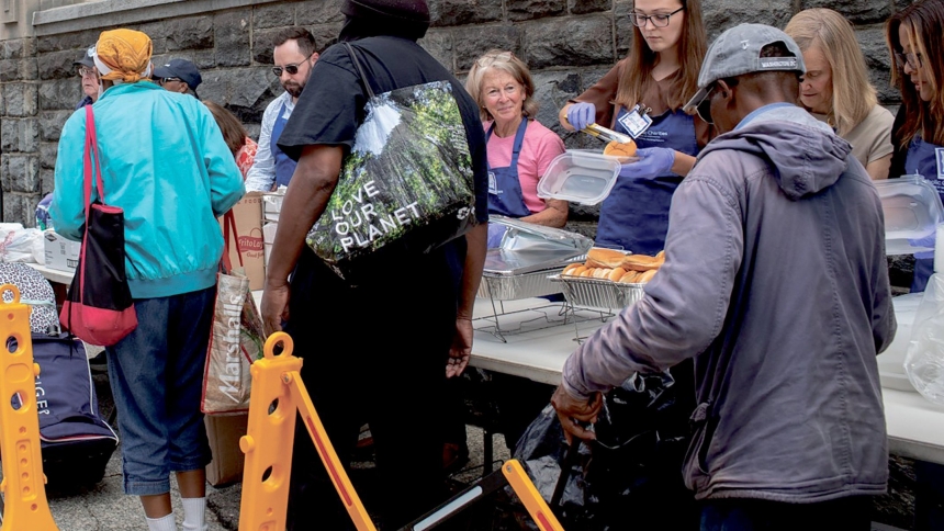 Volunteers serve meals to guests at Catholic Charities’ St. Maria’s Meals program Aug. 20, 2025. Every Wednesday afternoon outside Catholic Charities headquarters in Washington, the St. Maria’s Meals program serves hot and nutritious meals to people experiencing homelessness or food insecurity. Catholic Charities of the Archdiocese of Washington has expanded its homeless shelter capacity in the District of Columbia as homeless encampments are being removed across the nation’s capital. (OSV News photo/courte