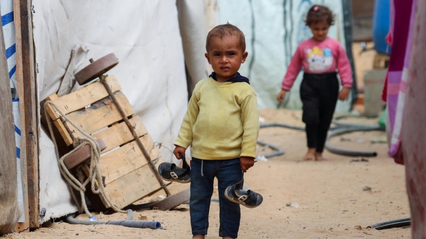 A Palestinian child stands between tents Oct. 6, 2025, where displaced Palestinians, who fled northern Gaza due to an Israeli military operation, shelter in the central Gaza Strip. (OSV News photo/Dawoud Abu Alkas, Reuters)