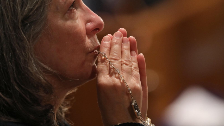 A woman becomes emotional as she prays with a rosary during Eucharistic adoration following the opening Mass of the National Prayer Vigil for Life Jan. 19, 2023, at the Basilica of the National Shrine of the Immaculate Conception in Washington. (OSV News photo/Bob Roller)