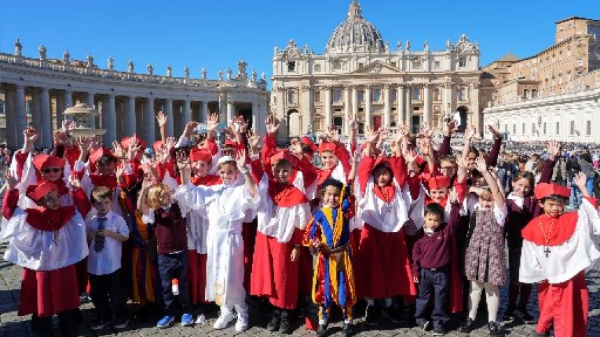 Students from Our Lady of Mount Carmel Academy in Chicago dressed as cardinals, a Swiss Guard and a pope pose in St. Peter’s Square at the Vatican Oct. 8, 2025. The students had captured worldwide attention when they held a mock conclave at their school May 6, electing their own “pope,” fourth grader Augie Wilk, who took the name “Pope Augustine,” just days before the election of Pope Leo, a fellow Chicagoan and Augustinian. (CNS photo/Lola Gomez)