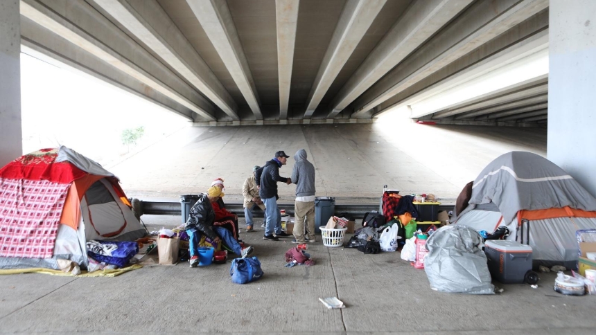 Homeless men in 2019 are seen outside their tents under a bridge on in Austin, Texas. (OSV News photo/CNS file, Bob Roller)