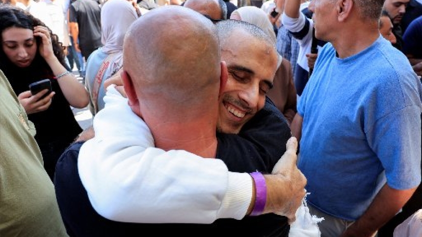 A freed Palestinian prisoner hugs his family member in Ramallah, in the Israeli-occupied West Bank, Oct. 13, 2025, after being released from an Israeli jail as part of a hostages-prisoners swap and a ceasefire deal in Gaza between Hamas and Israel. (OSV News photo/Mussa Qawasma, Reuters)