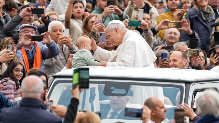 Pope Leo XIV greets a child from the popemobile as he rides around St. Peter's Square at the Vatican before his weekly general audience Oct. 22, 2025. (CNS photo/Lola Gomez)