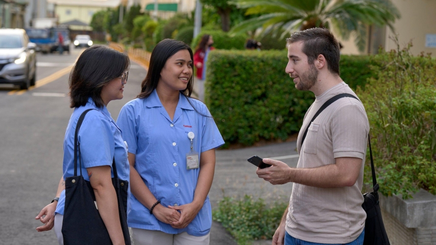 Charles Niece, the director of human rights and supply chain transparency, a Maryknoll project based in Taiwan, talks with workers as they leave work at a camera lens factory in Taichung, Taiwan, Oct. 24, 2024. (OSV News photo/Paul Jeffrey)