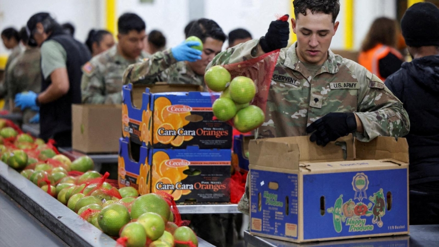 A member of the National Guard packs food at a Los Angeles Regional Food Bank facility Oct. 29, 2025, as nearly 42 million Americans face a potential lapse in Supplemental Nutrition Assistance Program (SNAP) benefits, known as food stamps, due to the second-longest U.S. government shutdown. (OSV News photo/Daniel Cole, Reuters)
