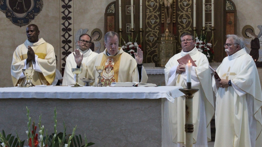 Bishop Robert J. McClory (center) celebrates the closing parish Mass at St. Stanislaus in East Chicago, although the church will remain open as a chapel for the adjacent school and for special services. With the bishop on Sept. 21 are (from left) Deacon Micky Henry, St. Stanislaus administrator Father Jeff Burton, Father Peter Muha and Father Tim McFarland, C.PP.S. (Marlene A. Zloza photo)