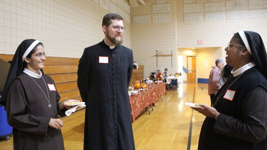 Father Ben Ross, pastor at St. Bridget in Hobart, talks with (left) Sister Benita Maria, C.M.C. and Sister Serene Jacob, C.M.C., both members of the Congregation of Mother of Carmel. St. Bridget hosted the annual luncheon hosted by the Serra Club of Northwest Indiana for religious sisters on Oct. 25. (Marlene A. Zloza photo)