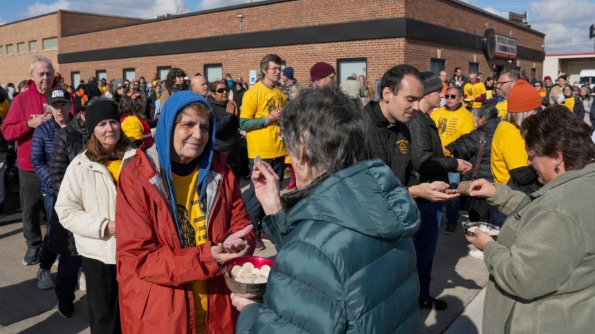 People receive Communion during an outdoor Mass in the Broadview section of Chicago Nov. 1, 2025, observed by interfaith leaders, community members, and volunteers, outside the Broadview ICE facility, after U.S. President Donald Trump ordered an increased federal law enforcement presence to assist in crime prevention. The Mass was led by Chicago Auxiliary Bishop José María Garcia-Maldonado. (OSV News photo/Leah Millis, Reuters)