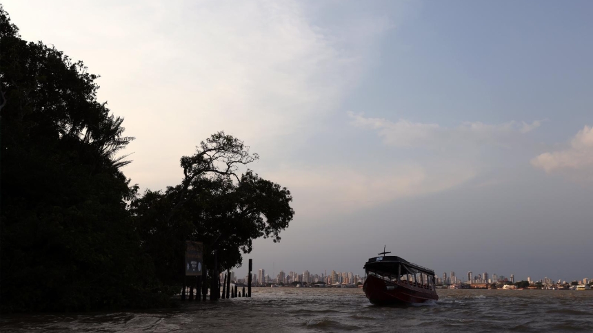 A boat is seen near Combu Island with the city of Belem, Brazil, in the background Nov. 9, 2025. Belem is hosting the U.N. Climate Conference, COP30. (CNS photo/Sergio Moraes, COP30)
