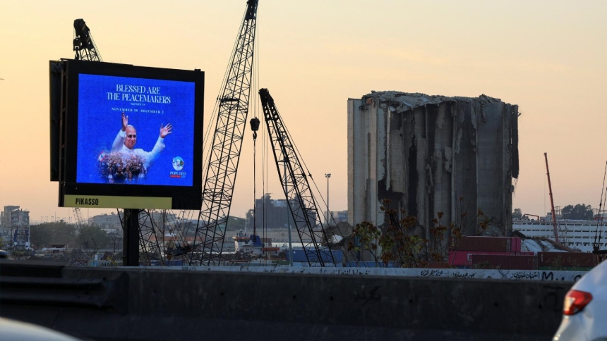 A digital billboard showing Pope Leo XIV stands along a road in Beirut Nov. 19, 2025, ahead of his planned visit to Lebanon. Nearby are partially collapsed grain silos that were damaged in the Aug. 4, 2020, Beirut port blast. (OSV News photo/Mohamed Azakir, Reuters)