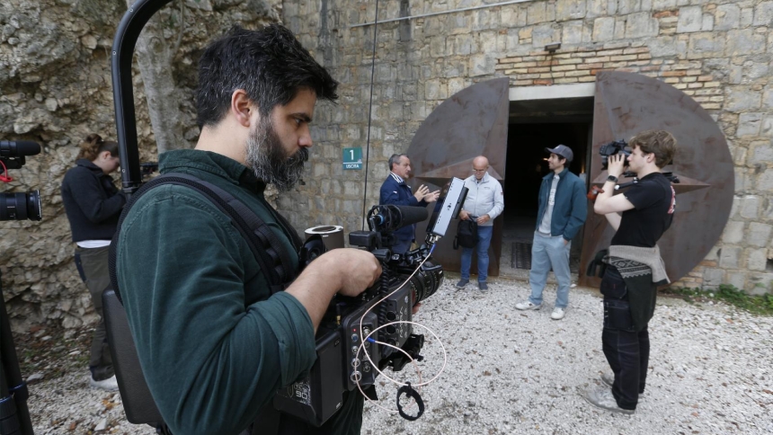 Sam Sorich, a Catholic filmmaker producing a documentary on Catholicism and UFOs, is seen filming a behind-the-scenes segment of an episode of Jesse Michels’ podcast on location in San Oreste, Italy, DATE, 2025. Michels and his production team were given a private tour of the Monte Soratte military bunker, where some people claim UFO technology was studied in the early 20th century. (CNS photo/Robert Duncan)