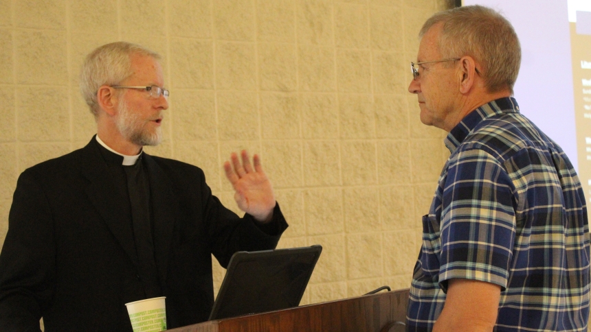 During an intermission between his two presentations on Nov. 8, Catholic ethicist Father Tad Pacholczyk, Ph.D., talks with attendee Jeffery Wozniak, a member of Parishioners for Life at St. Patrick in Chesterton and sexton of the parish cemetery. “Sacred Decisions on Life and Death,” was sponsored by the Diocese of Gary at Our Lady Queen of Martyrs South Campus in Merrillville. (Marlene A. Zloza photo)