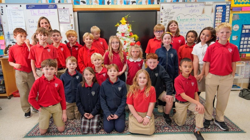 Hattie Halter, alias Cindy-Lou Who, center, poses in an undated photo with her third-grade classmates at St. Joseph School in Knoxville, Tenn. They are standing next to a Grinch-themed Christmas tree she and her classmates created for the Fantasy of Trees benefit Nov. 26-30 for East Tennessee Children's Hospital and its pediatric cancer-treatment program. Hattie, who was diagnosed with acute myeloid leukemia when she was 9 months old, is now cancer free seven years later. (OSV News photo/courtesy Kathy Rank