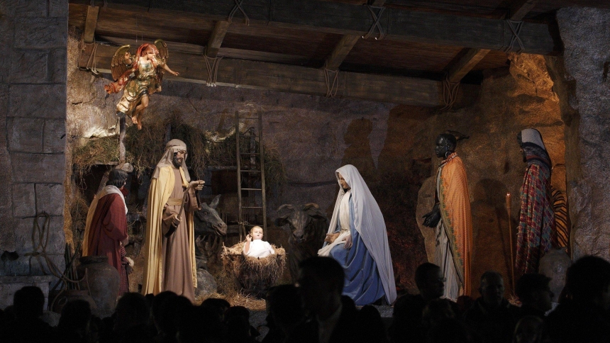 A file photo shows people visiting the Nativity scene in St. Peter's Square after Christmas Eve Mass at the Vatican. (CNS photo/Paul Haring)