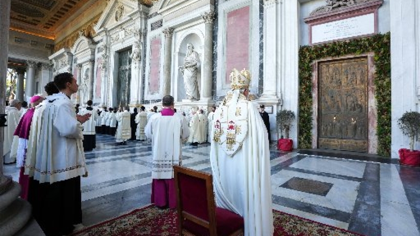 Cardinal James M. Harvey, archpriest of Rome's Basilica of St. Paul Outside the Walls stands in front of the basilica's Holy Door after solemnly closing it Dec. 28, 2025, as the Jubilee Year drew to a close. (CNS photo/Lola Gomez)