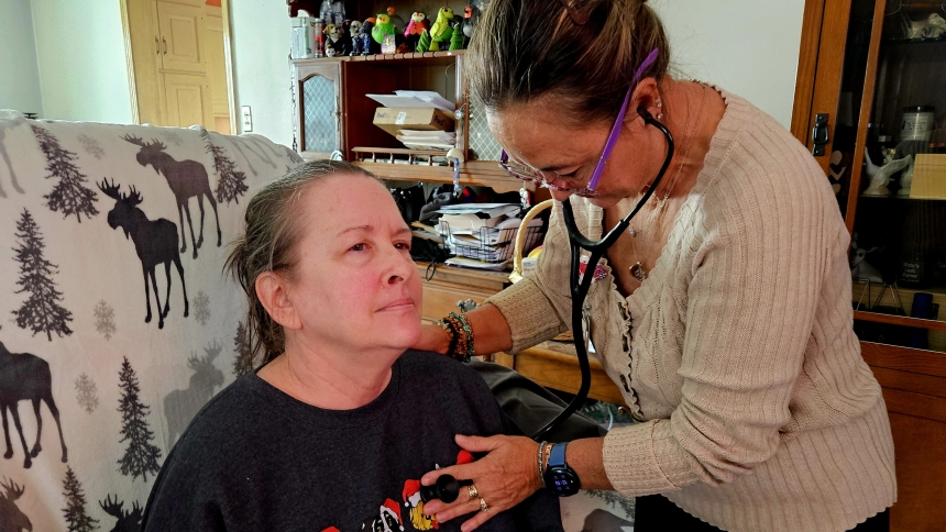 Amber Morris, left, is examined in her home by Franciscan Health Palliative Care Nurse Practitioner Vickie Allison.