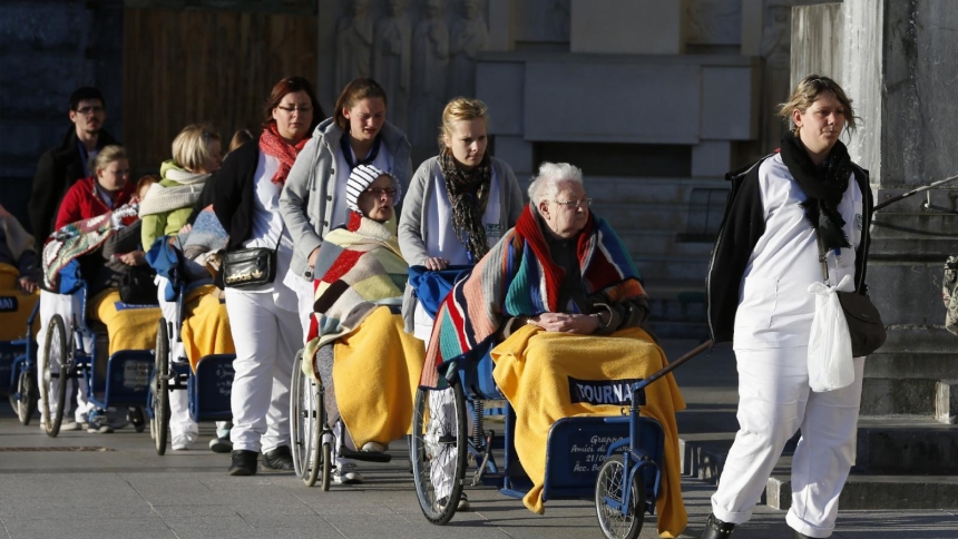 Caregivers push the sick and disabled at the Shrine of Our Lady of Lourdes in southwestern France in this May 16, 2014, file photo. In a message for the Feb. 11 World Day of the Sick, Pope Francis emphasized a patient-centered approach to medical care. (CNS photo/Paul Haring)