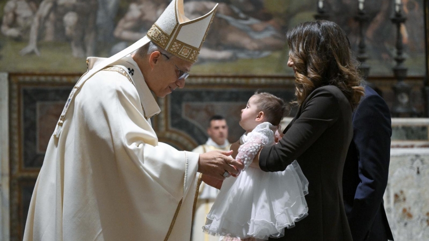 Pope Leo XIV greets a mother and child as he baptizes 20 children in the Sistine Chapel at the Vatican Jan. 11, 2026, the feast of the Baptism of the Lord. (OSV News photo/Simone Risoluti, Vatican Media)