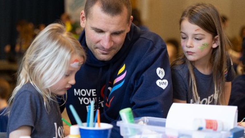 Matt Stommes works with his twin daughters, Etta and Esme, at at Annunciation Catholic School in Minneapolis Jan. 10, 2026, for FletcherFest in honor of Fletcher Merkel, who died in an Aug. 27, 2025, shooting during an all-school Mass at Annunciation Church in south Minneapolis. The event featured food, games and socializing as people celebrated Fletcher's life. (OSV News photo/Dave Hrbacek, The Catholic Spirit)