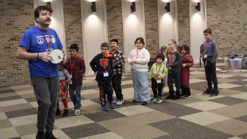 Adam White of the Music Ministry at St. Maria Goretti in Dyer, leads children on a musical procession to teach them about movement during the Christmas Vacation Bible Day on Dec. 29. They also sang “Go Tel It On The Mountain,” “Silent Night” and “Joy to the World” to celebrate Jesus Christ’s birth. (Marlene A. Zloza photo)