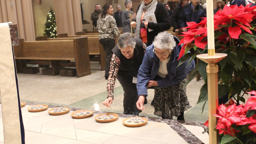Maria Sanchez (left) and Beatrice Chavez, both from Lake Station, place incense crystals on one of several plates set out at the foot of the altar during Solemn Vespers on Jan. 4 at the Cathedral of the Holy Angels in Gary. Worshippers were invited to incense the monstrance holding the Holy Eucharist as the Diocese of Gary officially closed the Jubilee Year of 2025, as Pope Leo XIV did at the Vatican earlier in the week. (Marlene A. Zloza photo)