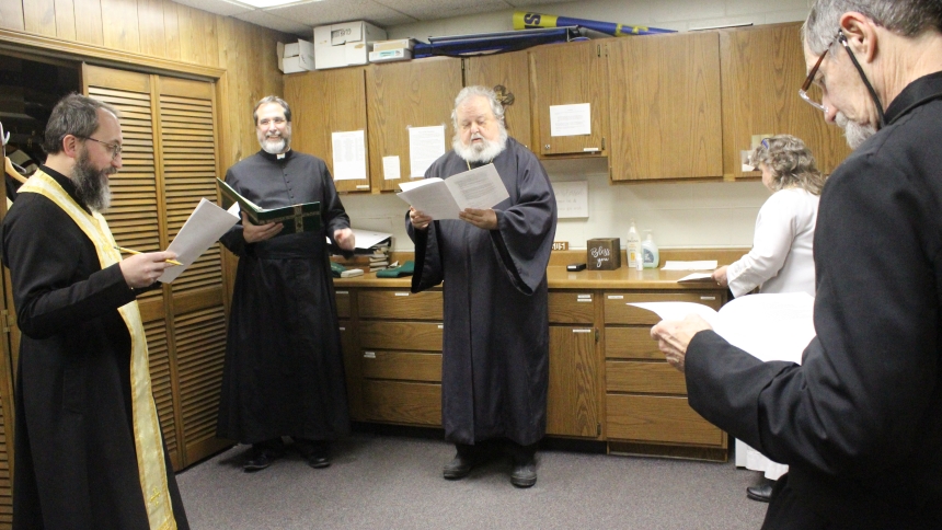 Reviewing the schedule for the Prayer Service for Christian Unity in the sacristy at St. Elizabeth Ann Seton in Valparaiso on Jan. 22 are (second from  left} Father Michael Kopil, pastor, and guest celebrants (from left) Father Michal Buchko of St. Michael Byzantine Catholic Church in Merrillville, Father Lev Holowaty of Descent of the Holy Spirit Orthodox Church in Schererville, Pastor Esta Rosario of Chesterton United Methodist Church and Father Douglas Mayer, pastor of St. Paul Catholic Church in Valpara