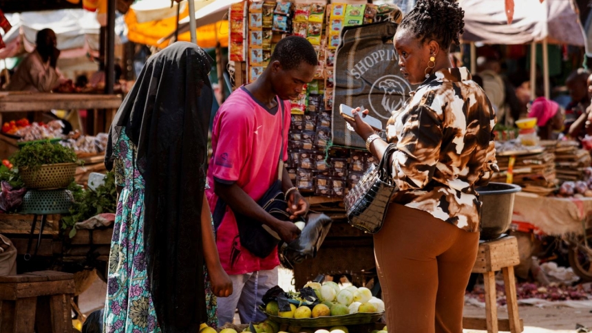 A woman holds a smartphone at a market in Garoua, Cameroon, Oct. 30, 2025. Cameroon’s possible inclusion in Pope Leo XIV’s first African trip is drawing growing debate, as security concerns, political tensions and moral objections raise questions about whether the country is ready for a papal visit. (OSV News photo/Desire Danga Essigue, Reuters)