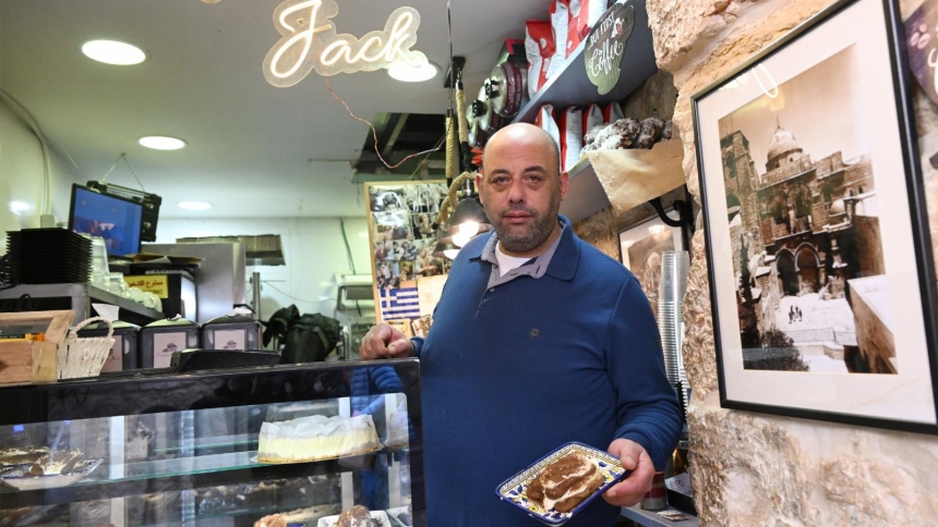 Jack Amer poses with a pastry in his cafe Patisserie in the Old City of Jerusalem Feb. 10, 2026. (OSV News photo/courtesy Debbie Hill)