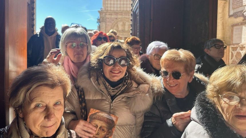 Pilgrims from the Marche region of Italy enter the Lower Church of the Basilica of St. Francis in Assisi, Italy, Feb. 22, 2026, to visit the relics of St. Francis on display for veneration. (OSV News photo/Courtney Mares)