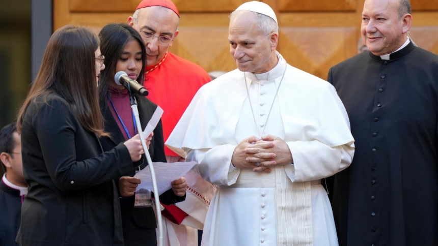 Pope Leo XIV listens as a young woman reads remarks during a pastoral visit to the Basilica of the Sacred Heart of Jesus in central Rome Feb. 22, 2026. (CNS photo/Lola Gomez)