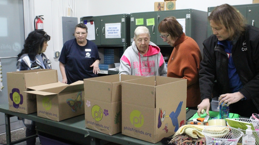 Romaine Ostrowski (second from left), a group leader at Phil’s Friends, directs volunteers (from left) Reny Pearman, Donna Kuhlmann, Donna Parker and Connie Jasik, all parishioners at St. John the Evangelist in St. John, as they fill care boxes for cancer patients during a Feb. 20 service project at the Christ-centered nonprofit agency’s Hope Center in Crown Point. The care packages are sent at no charge to cancer patients of all ages throughout the U.S., offering support and comfort. (Marlene A. Zloza phot