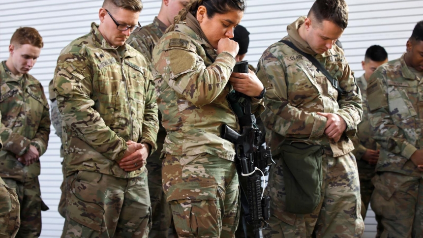 Soldiers from the U.S. Army’s 82nd Airborne Division participate in a prayer session as they wait to board a transport plane at Fort Bragg, N.C., Feb.14, 2022. (OSV News photo/Jonathan Drake, Reuters)