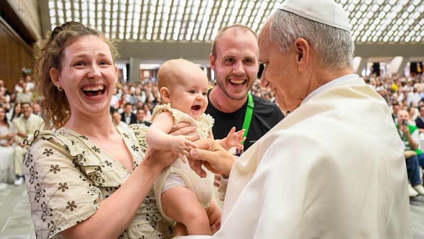Pope Leo XIV greets a baby and family at the conclusion of his weekly general audience in the Paul VI Audience Hall at the Vatican Aug. 27, 2025. (CNS photo/Vatican Media)