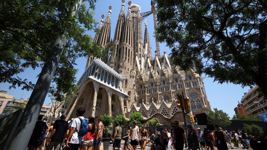 Groups of tourists walk around the Basilica of the Holy Family, known in Spanish as Sagrada Familia, in Barcelona, Spain, June 30, 2025. Pope Leo XIV will visit Barcelona in June 2026 to mark the centenary of the death of the Sagrada Familia’s iconic architect, Antoni Gaudí, a candidate for sainthood declared venerable by Pope Francis April 14, 2025. (OSV News photo/Albert Gea, Reuters)
