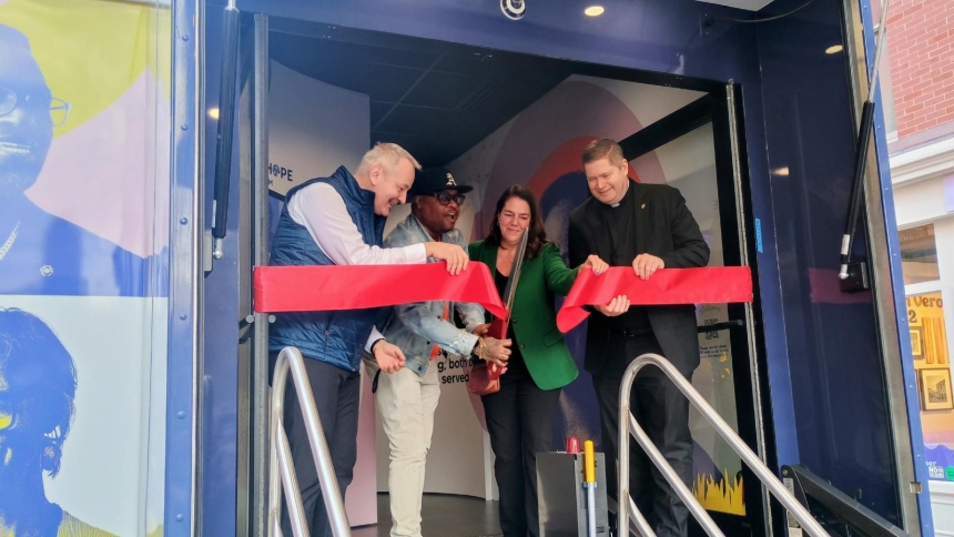 Jamar Carr, a substance abuse counselor with Catholic Charities in the Diocese of Brooklyn, N.Y., cuts the ceremonial ribbon during the launch of a three-year journey of Catholic Charities USA's People of Hope Museum March 26, 2026, in Manhattan. Under the sponsorship of Catholic Charities USA, the tractor-trailer-sized traveling museum will tour the country highlighting "the impact of neighbors helping neighbors, and celebrating the power of Christian service," organizers said. (OSV News photo/Armando Mach