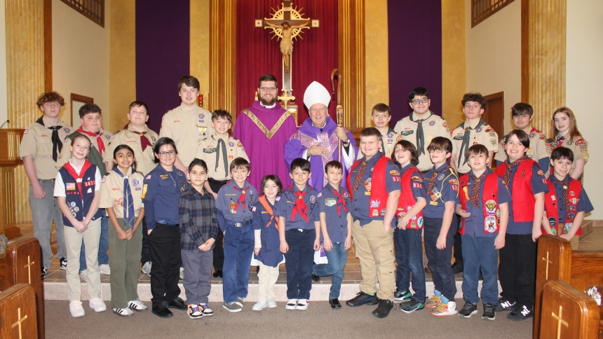 Scouts and American Heritage Girls are congratulated by (back row center) Diocese of Gary scout chaplain Father Benjamin Ross and Bishop Robert J. McClory after receiving their religious emblems during the Gary Diocese Catholic Committee on Scouting Mass hosted by St. Bridget in Hobart on March 1. Families were invited to a reception after the annual Mass. (Marlene A. Zloza photo)