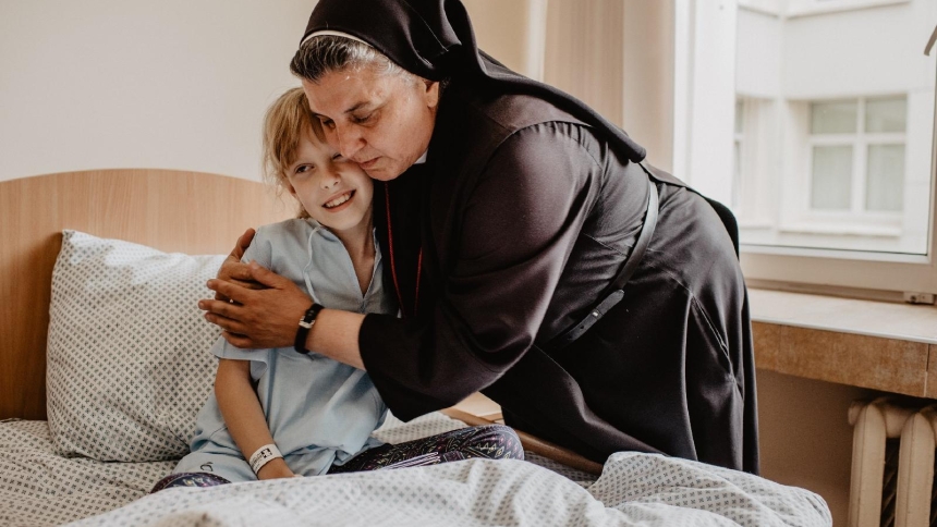 Sister Michaela Rak of the Sisters of Merciful Jesus hugs a patient in the Hospice of Blessed Michal Sopocko in an undated photo in Vilnius, Lithuania. (OSV News photo/courtesy Hospice of Blessed Michal Sopocko)