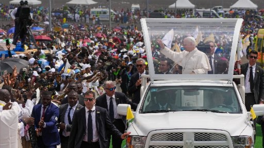 Pope Leo XIV waves to the crowds as he rides in the popemobile among the faithful as he arrives outside Japoma Stadium in Douala, Cameroon, April 17, 2026. (CNS photo/Lola Gomez)