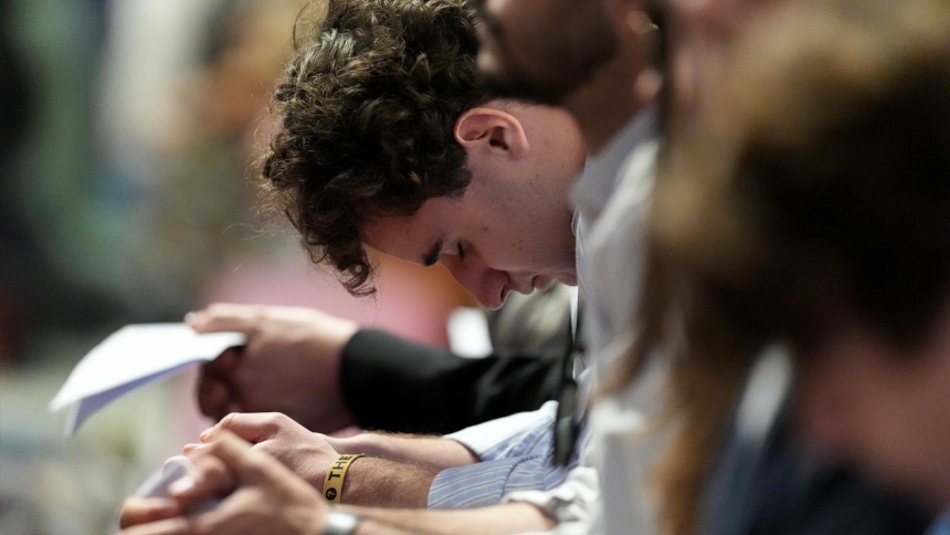 A young man bows his head in prayer during Holy Thursday’s Mass of the Lord's Supper at the Altar of the Chair in St. Peter's Basilica at the Vatican April 17, 2025. (CNS photo/Lola Gomez)