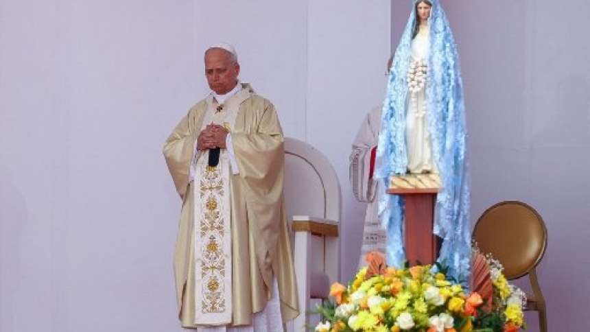 Pope Leo XIV stands next to a figure of the Virgin Mary on the day he leads a Holy Mass during his apostolic journey in Africa, in Kilamba, Luanda province, Angola, April 19, 2026. (OSV News/Guglielmo Mangiapane, Reuters)