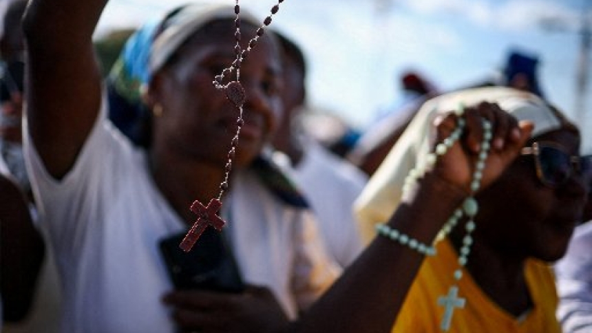 People hold rosaries ahead of the rosary prayer led by Pope Leo XIV at the "Mama Muxima" Shrine, during his apostolic journey in Africa, in Muxima, Angola, April 19, 2026. (OSV News photo/Guglielmo Mangiapane, Reuters)