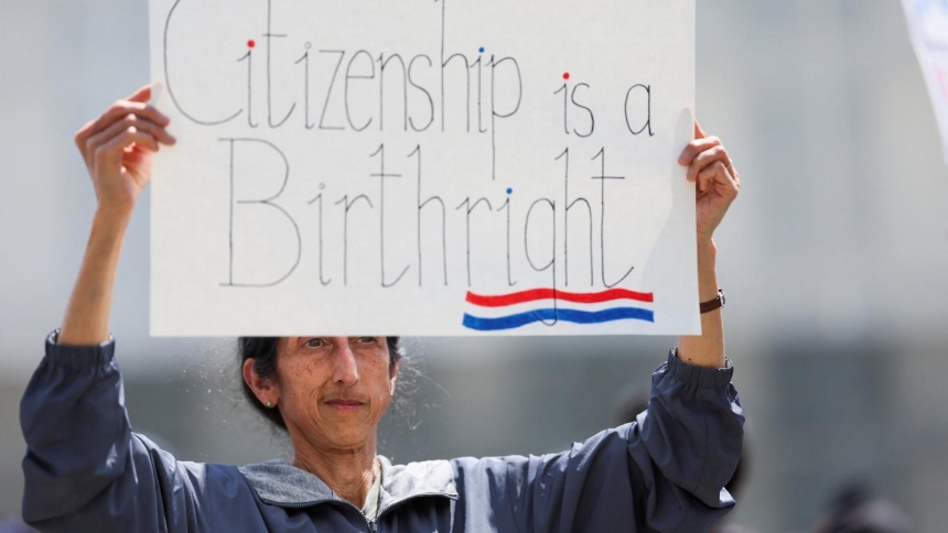 A demonstrator holds a placard during a protest outside the Supreme Court May 15, 2025. On April 1, 2026, the court will hear oral arguments in Trump v. Barbara, a challenge to an executive order by President Donald Trump ending birthright citizenship. (OSV News photo/Leah Millis, Reuters)